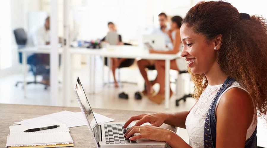 black woman on laptop using perfect invoice template for business