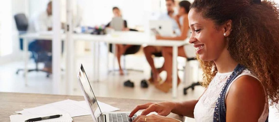 black woman on laptop using perfect invoice template for business